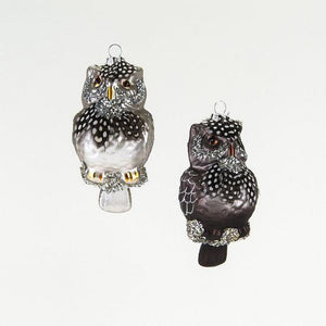 Image of two owl Christmas ornaments with real feathers on their heads and necks. One owl is silver with black spotted feathers and the other is dark grey with dark spotted feathers