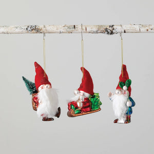 Image of a Christmas ornament that is a gnome figure holding mistletoe. It is glass with a faux fur beard and felt hat.