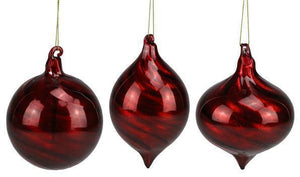 Image of a red ball elongated oval and onion shaped Christmas ornament with swirls in the glass